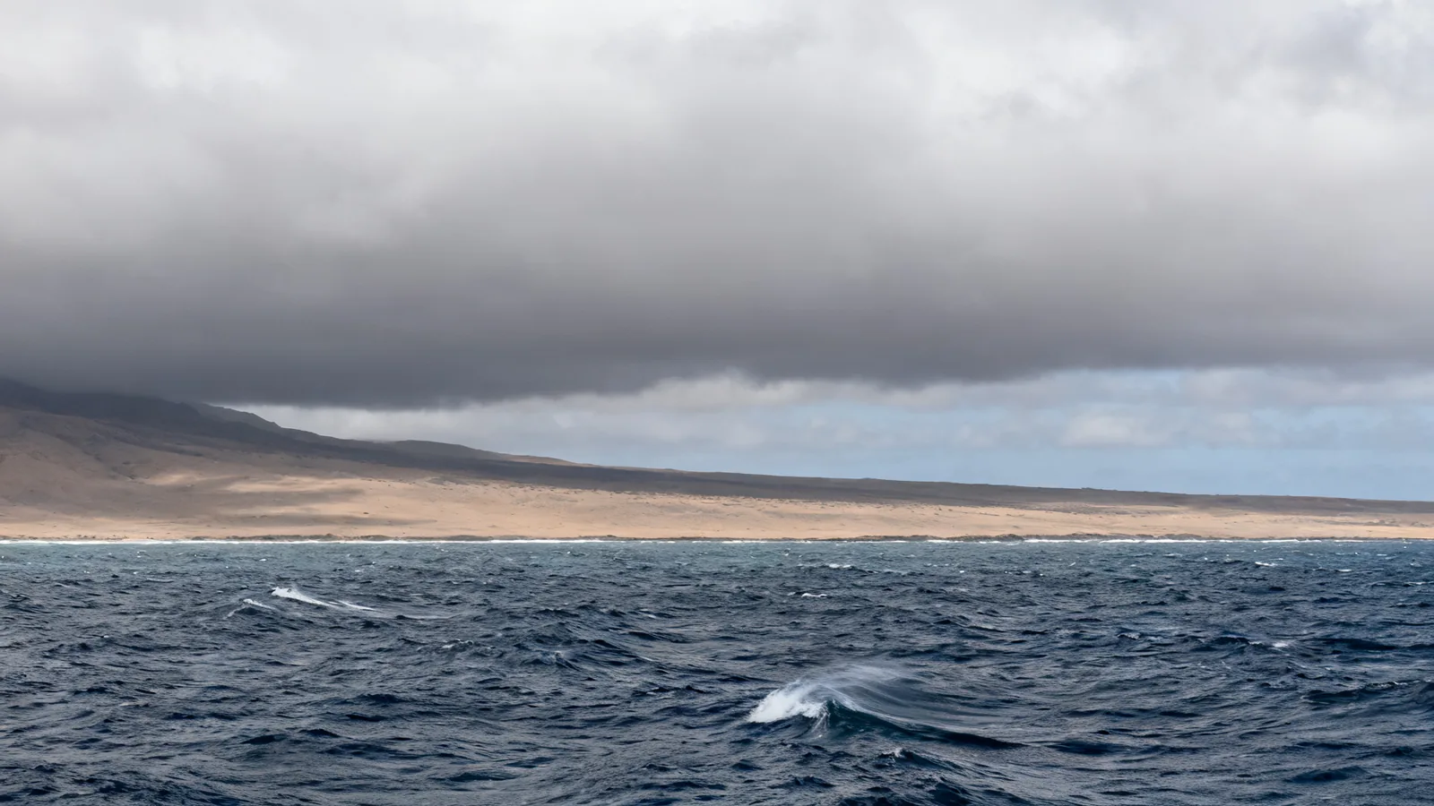Cloud over rough Pacific water, photographic illustration